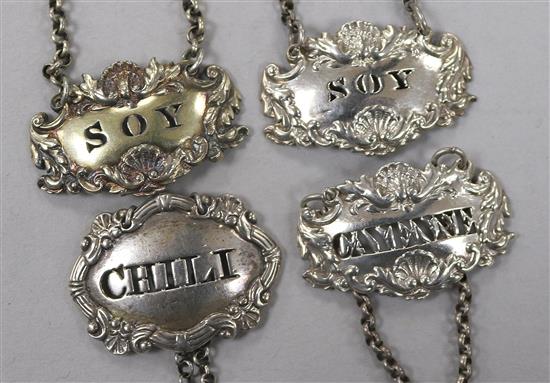 Four George III and later silver sauce labels;